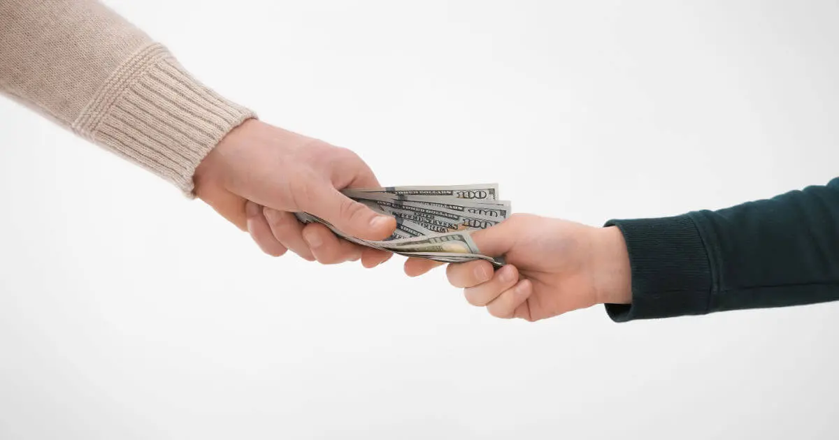 Male & female grabbing money, a legal battle for alimony. MBH Fort Worth | Family Law attorneys can help.